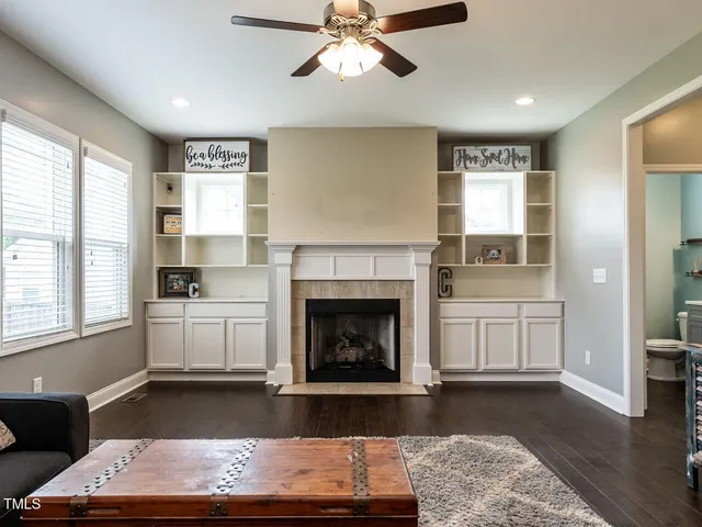 a living room with furniture fireplace and window