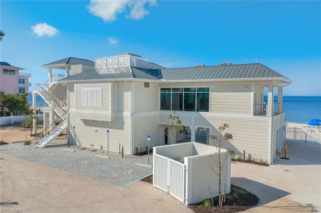 a living room with lots of furniture and a large window
