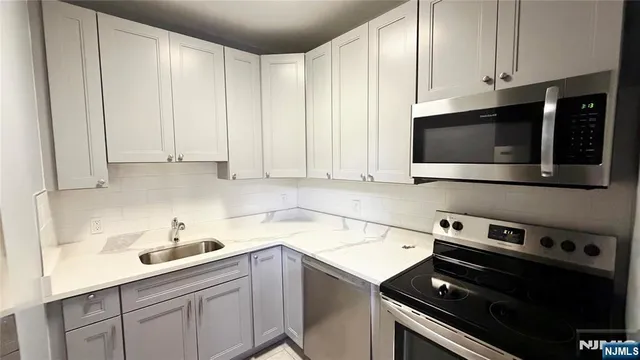 a kitchen with a sink and cabinets