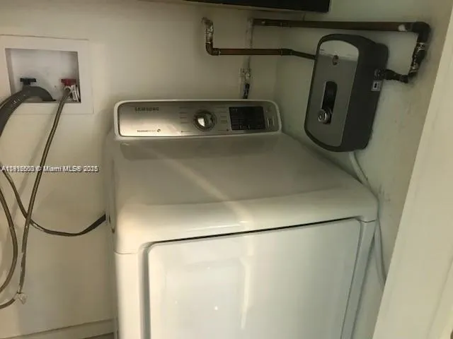 a close view of water heater room washer and dryer