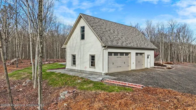 a front view of a house with yard outdoor seating and barbeque oven