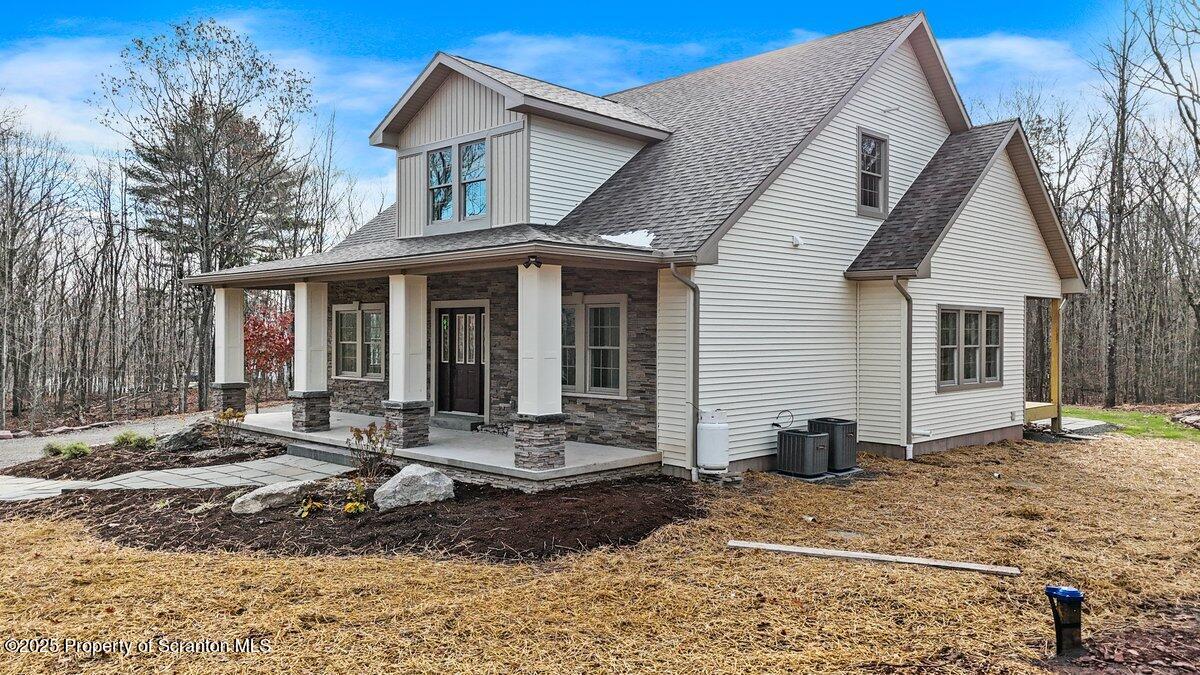 434 Summit Woods Road Moscow, PA 18444 - Photo 14 of 19 a front view of a house with yard outdoor seating and barbeque oven