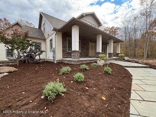 434 Summit Woods Road Moscow, PA 18444 - Photo 18 of 19 a front view of a house with garden