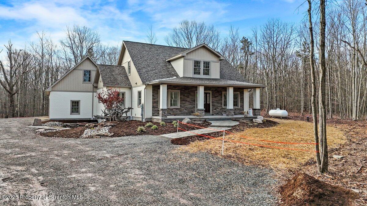 434 Summit Woods Road Moscow, PA 18444 - Photo 5 of 19 a view of a house with backyard and sitting area