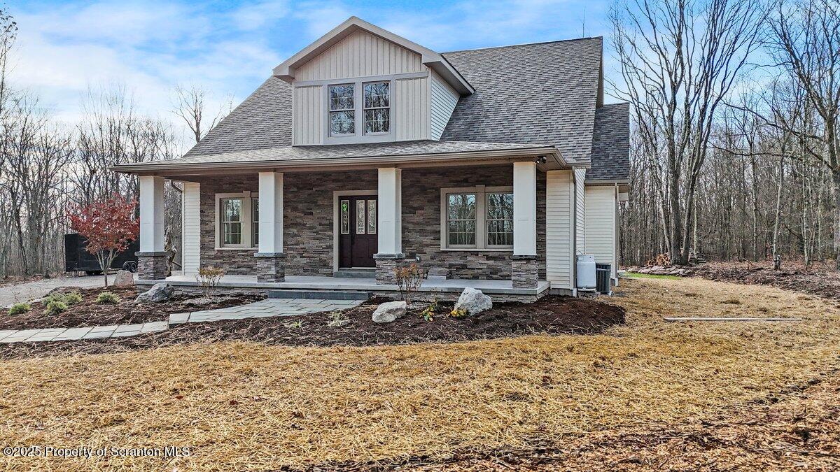 434 Summit Woods Road Moscow, PA 18444 - Photo 8 of 19 a view of a white house with a small yard and large tree