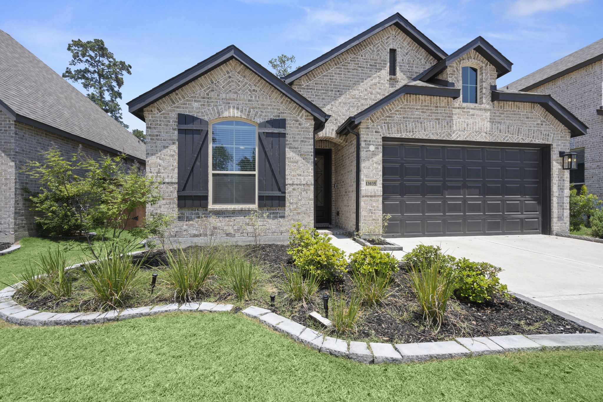 13035 Wandering Rdg Lane Conroe, TX 77302 - Photo 2 of 28 a front view of a house with a yard