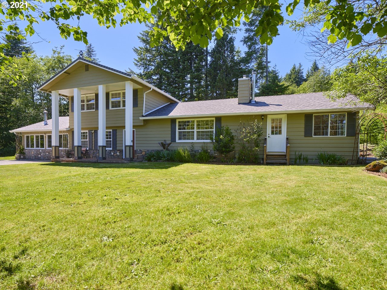 6121 Northeast Lessard Road Camas, WA 98607 - Photo 1 of 26 a front view of a house with a yard