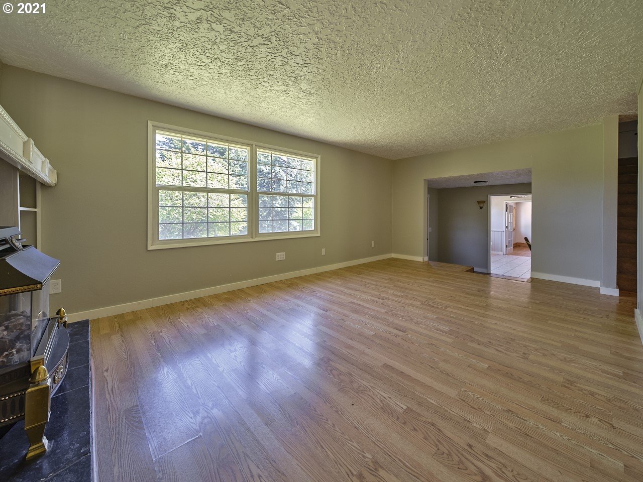 6121 Northeast Lessard Road Camas, WA 98607 - Photo 8 of 26 an empty room with wooden floor and windows