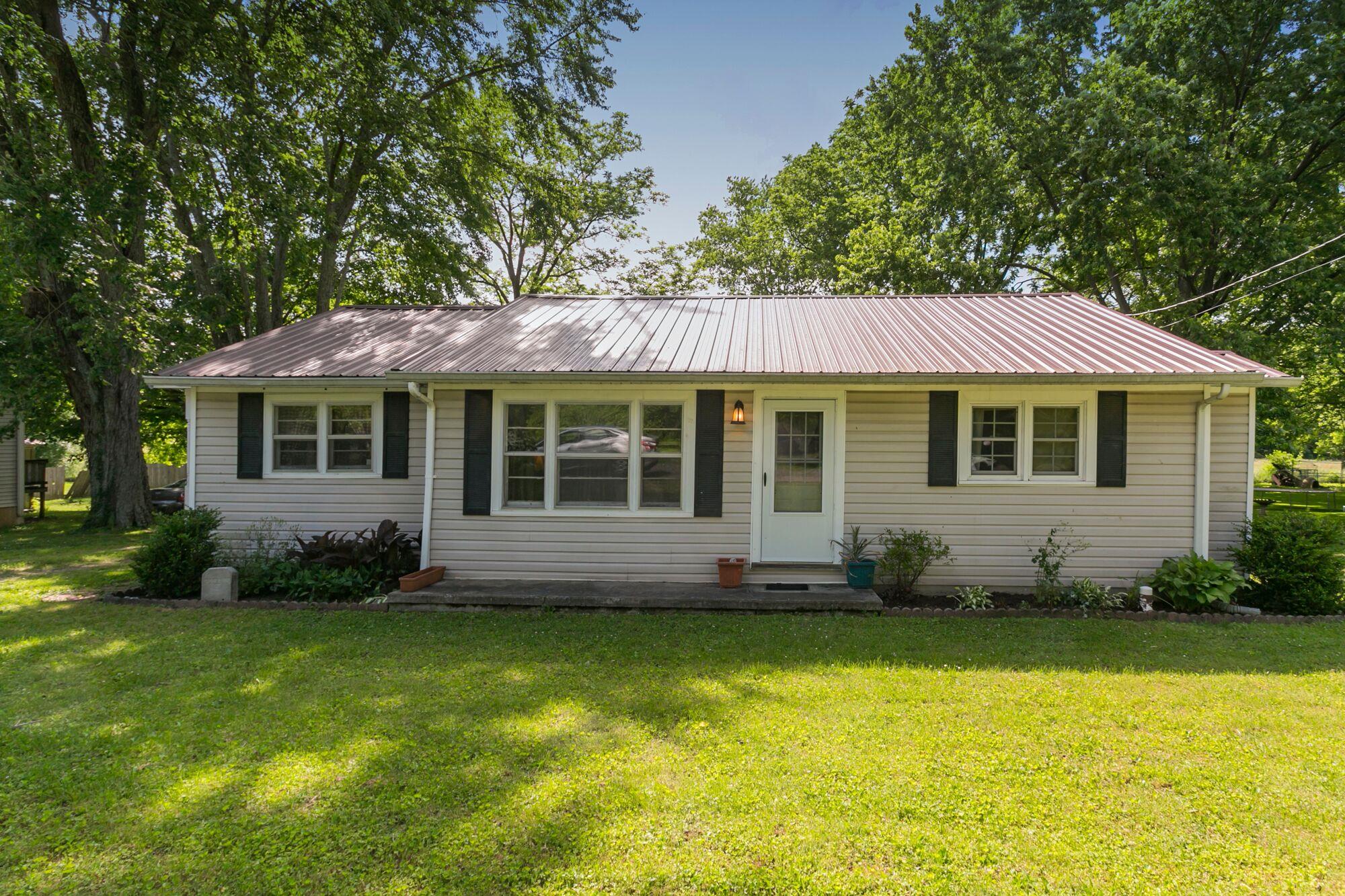 108 North Street Portland, TN 37148 - Photo 2 of 21 a front view of a house with a garden and porch