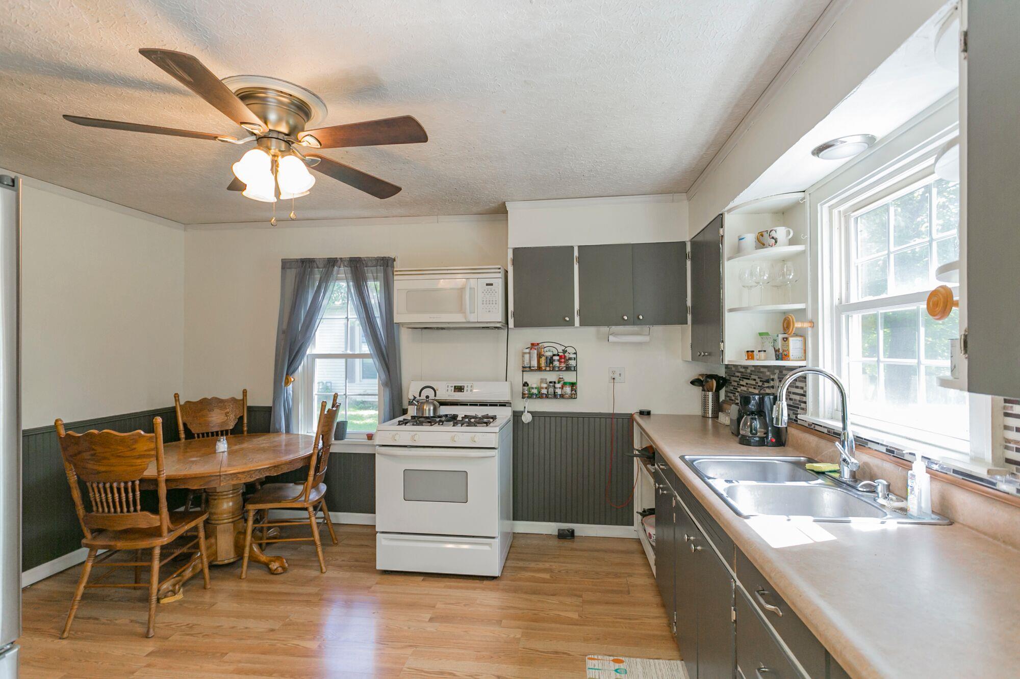 108 North Street Portland, TN 37148 - Photo 11 of 21 a kitchen with a table chairs stove and cabinets