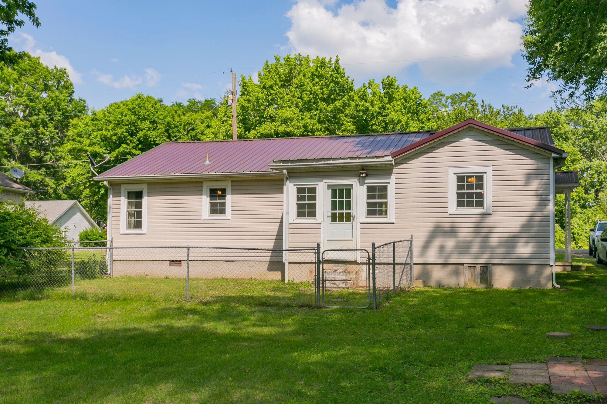 108 North Street Portland, TN 37148 - Photo 19 of 21 a view of a yard in front of a house with plants and large tree