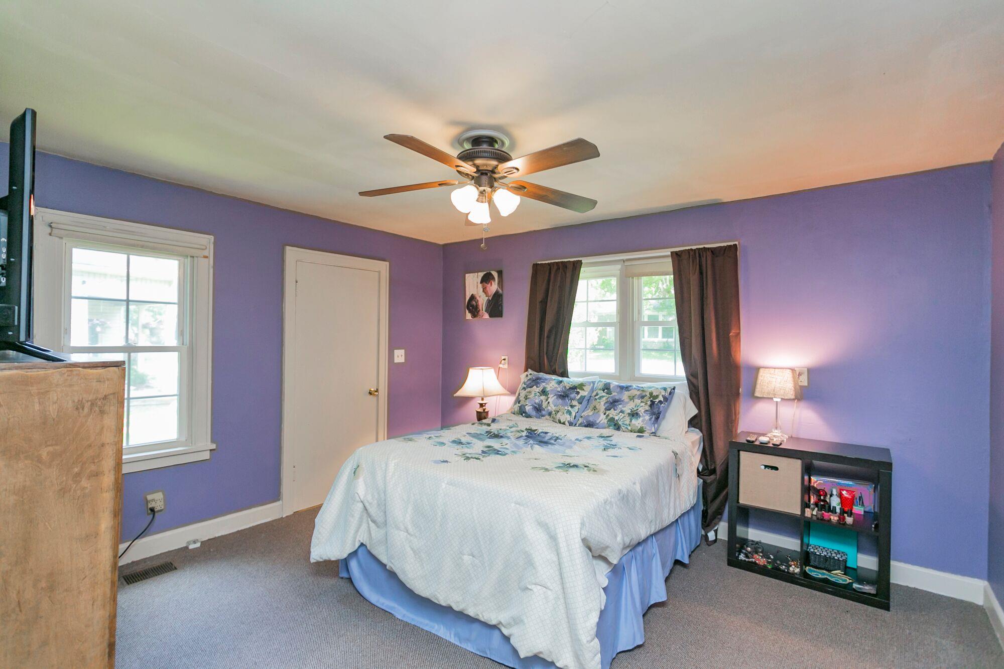 108 North Street Portland, TN 37148 - Photo 6 of 21 a bedroom with a bed and a chandelier