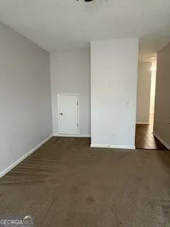 a view of an empty room and wooden floor