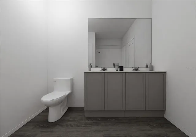 a bathroom with a sink a toilet and mirror