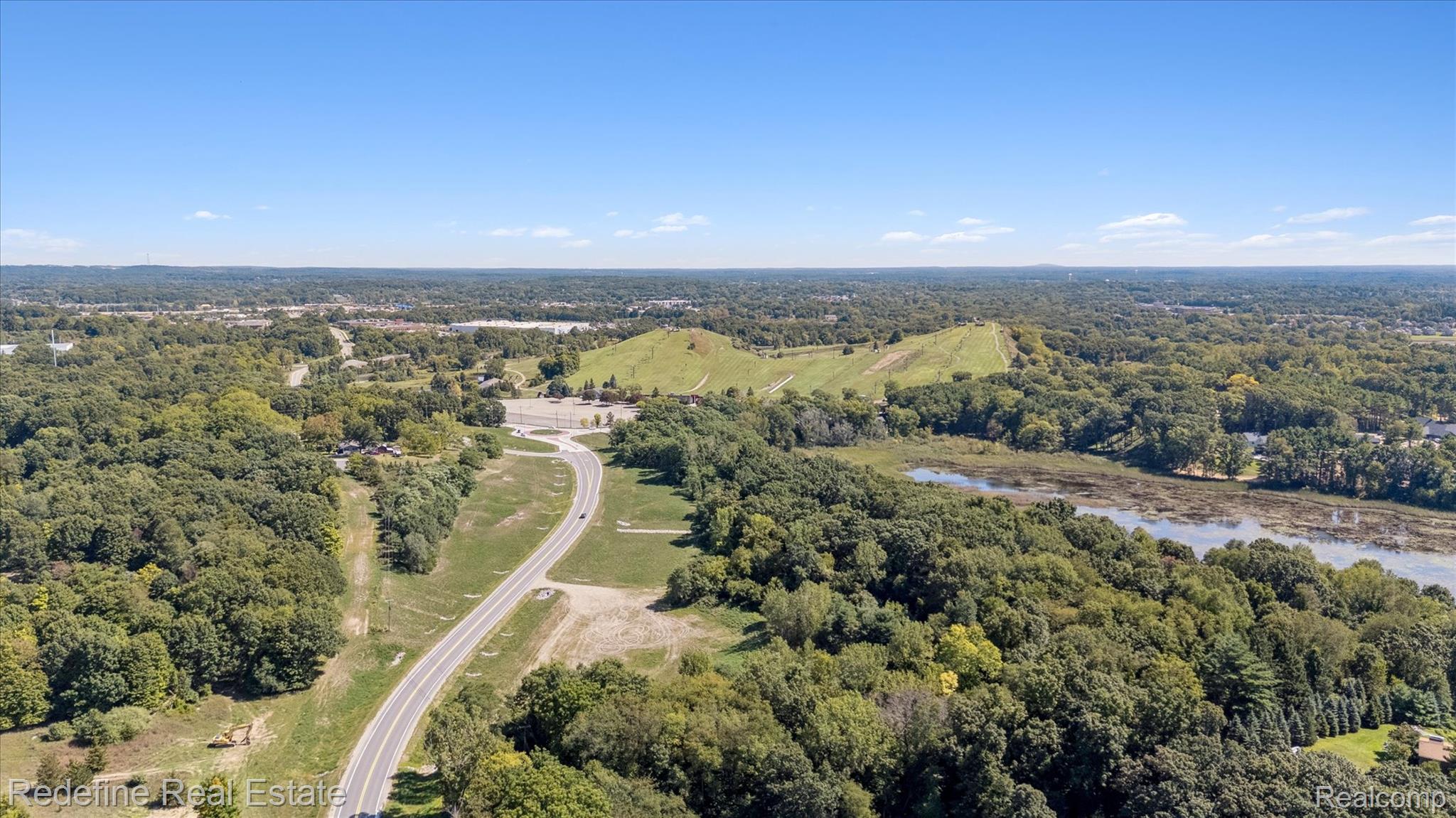 3777 Dorr Road Brighton, MI 48116 - Photo 60 of 77 Drone / aerial view of a forest and a large body of water