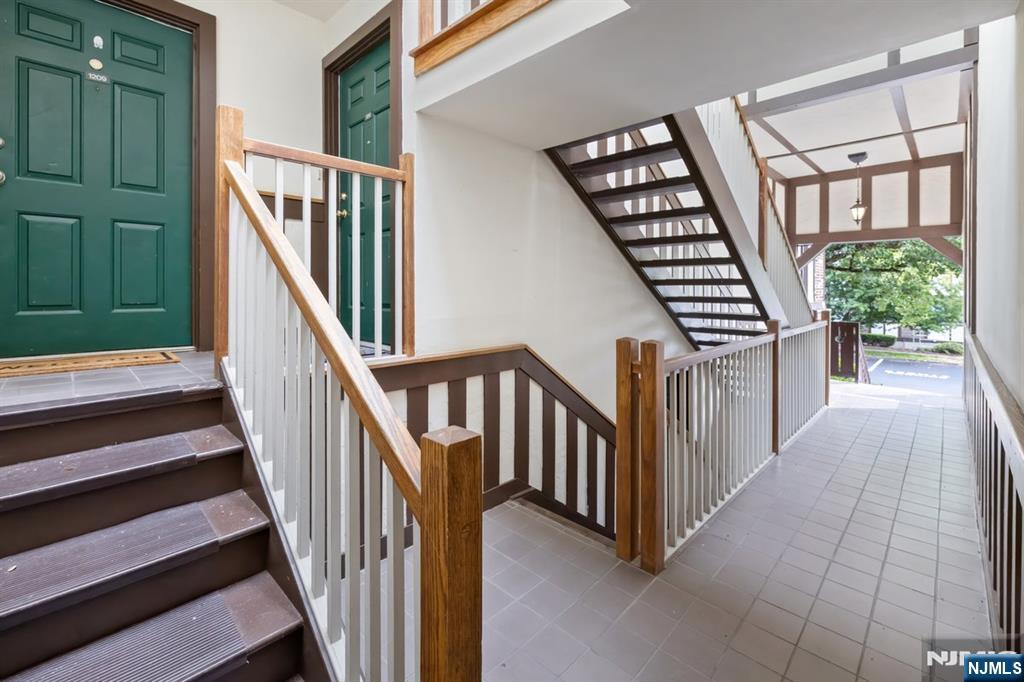 1209 Faulkner Court Mahwah, NJ 07430 - Photo 2 of 11 a view of staircase with lots of frames on wall and a window