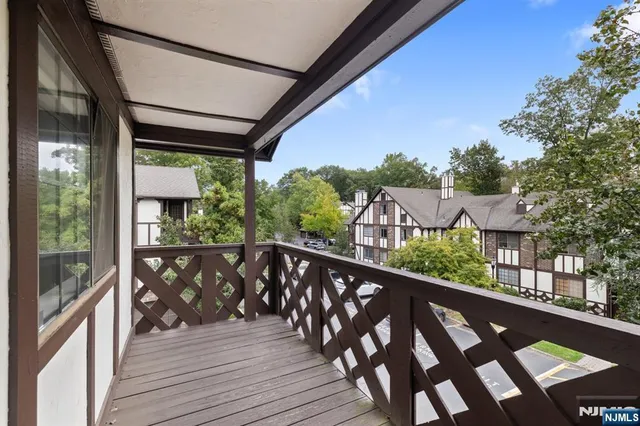 a view of a balcony with wooden floor