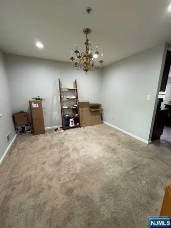 a view of a livingroom with a chandelier furniture and a chandelier