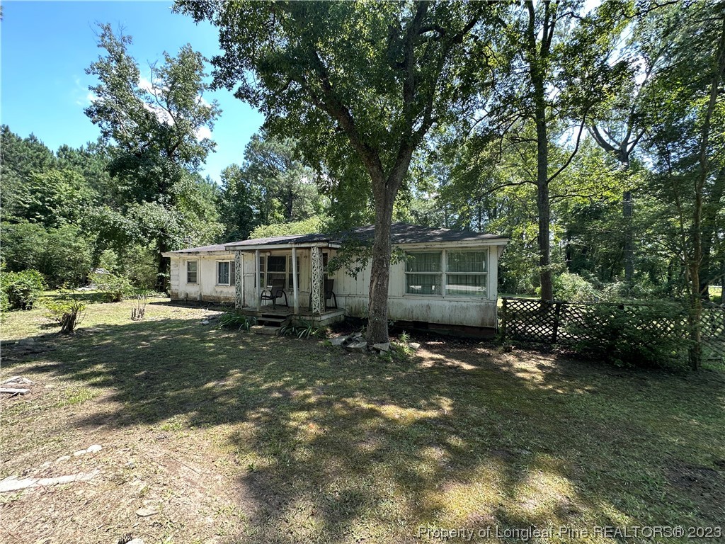 6682 Goldsboro Road Wade, NC 28395 - Photo 3 of 9 a view of a house with a yard