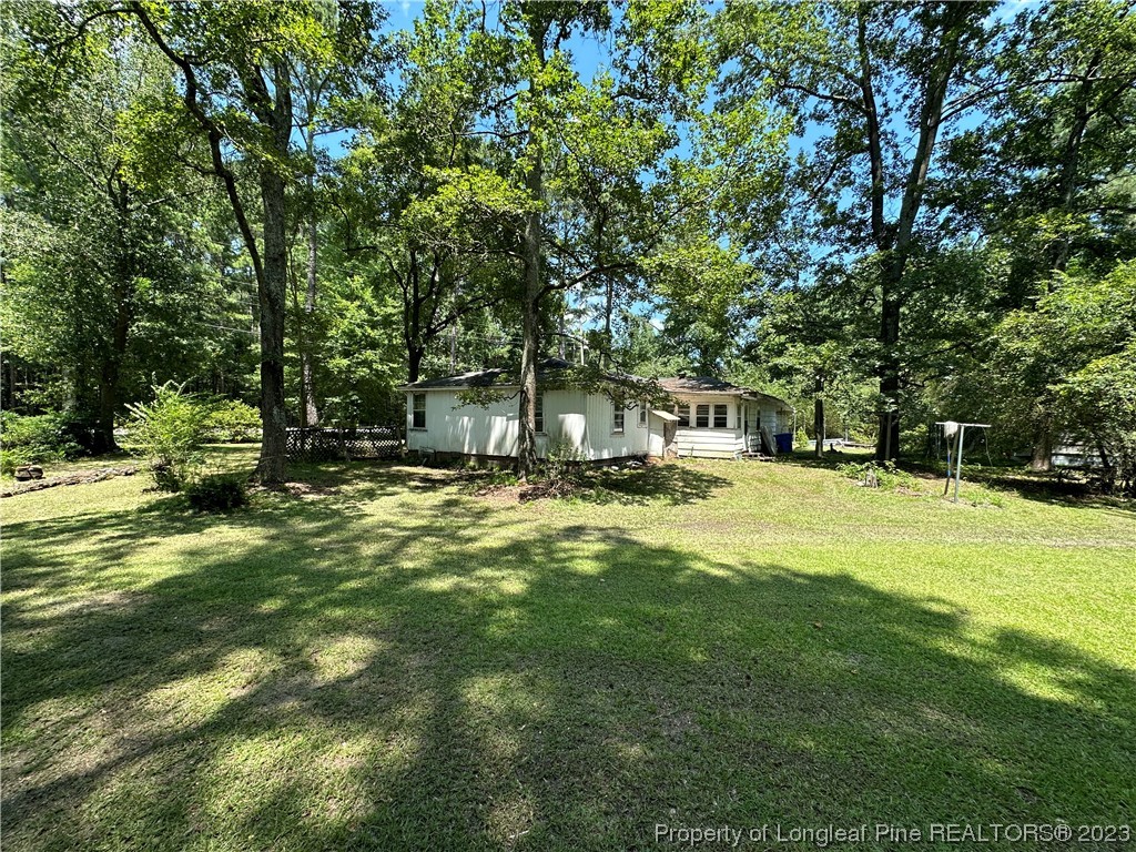 6682 Goldsboro Road Wade, NC 28395 - Photo 5 of 9 a house view with swimming pool
