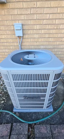 a view of a wooden chair and bench in the backyard