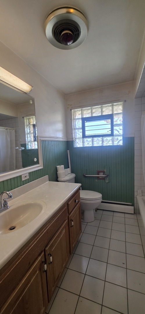 523 8th Street Chicago Heights, IL 60411 - Photo 6 of 31 a bathroom with a sink a toilet and window