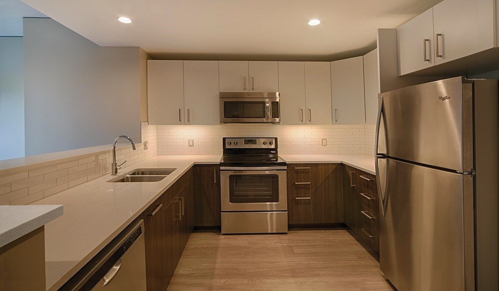 270 Third Street, Unit 513 Cambridge, MA 02142 - Photo 2 of 11 a kitchen with a refrigerator and a stove