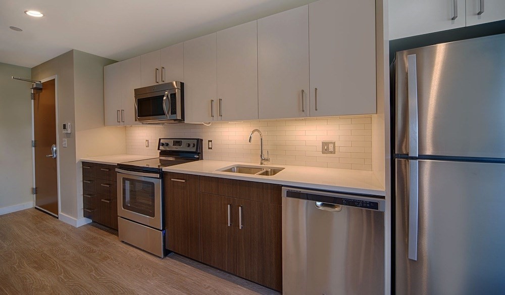 270 Third Street, Unit 513 Cambridge, MA 02142 - Photo 3 of 11 a kitchen with stainless steel appliances and a refrigerator