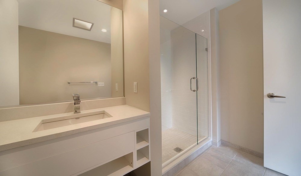 270 Third Street, Unit 513 Cambridge, MA 02142 - Photo 5 of 11 a bathroom with a sink a mirror and a vanity