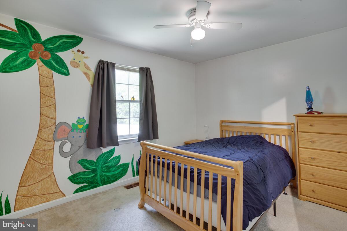 1420 Wilson Road Huntingtown, MD 20639 - Photo 22 of 43 a bedroom with a bed and a window