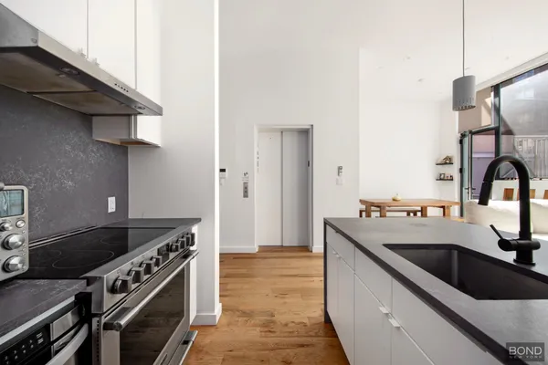 a kitchen that has a sink and a stove