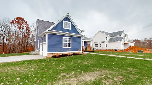 a kitchen with stainless steel appliances granite countertop a sink a stove and a wooden floors