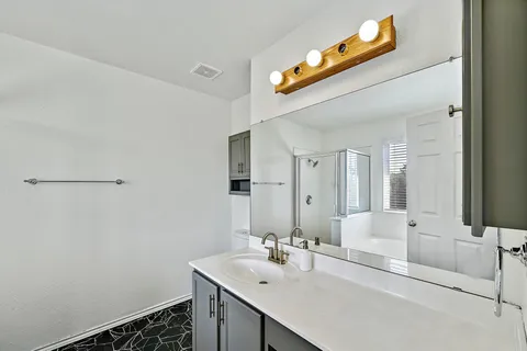 a bathroom with a sink and a mirror