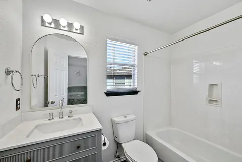 a bathroom with a toilet a sink and a bathtub