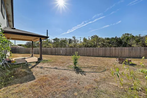 a view of a backyard with a slide and a swing