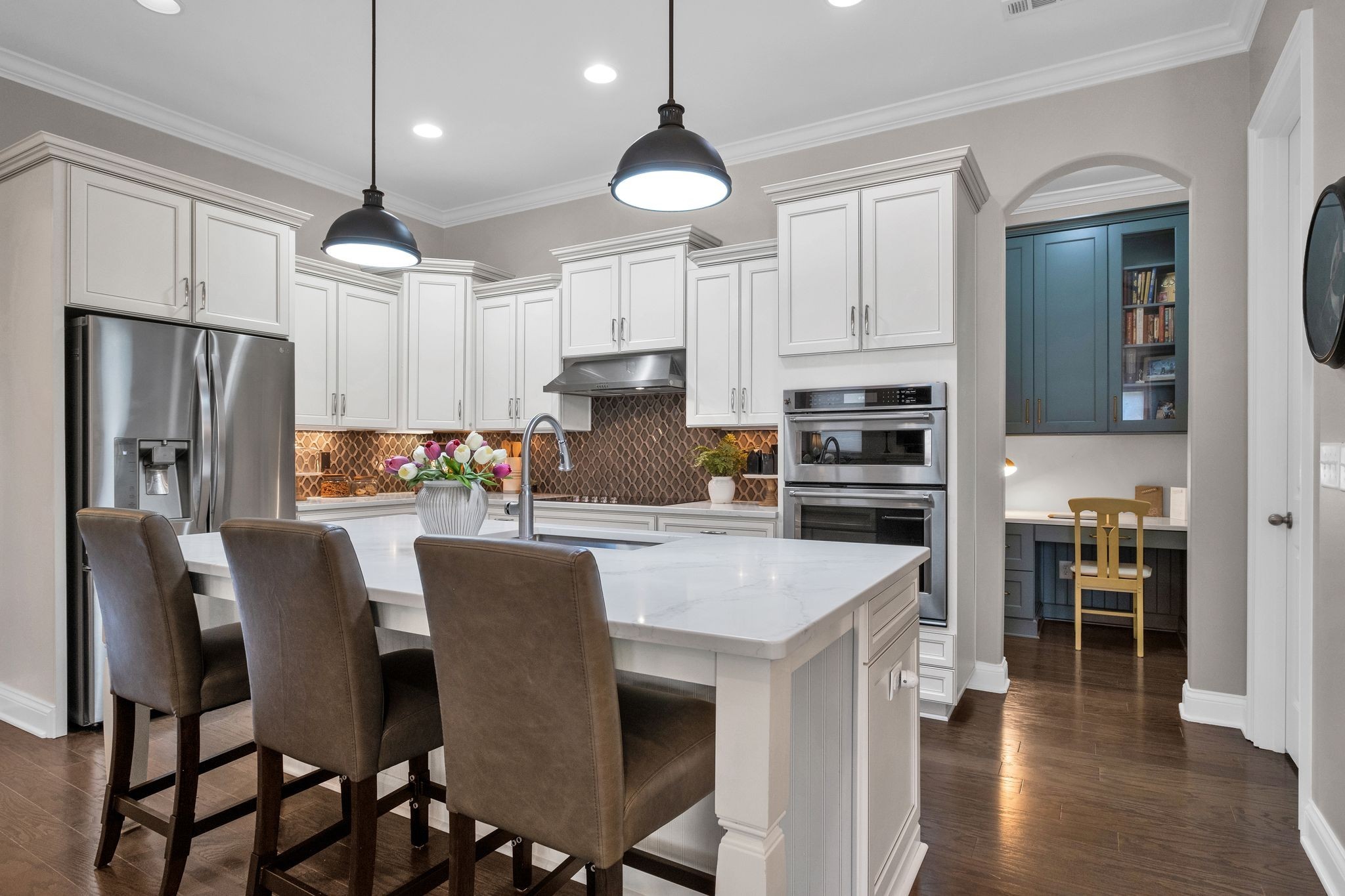 2505 Upper Hollow Road Thompson's Station, TN 37179 - Photo 2 of 52 a kitchen with stainless steel appliances granite countertop a stove refrigerator a oven a sink a dining table and chairs with wooden floor