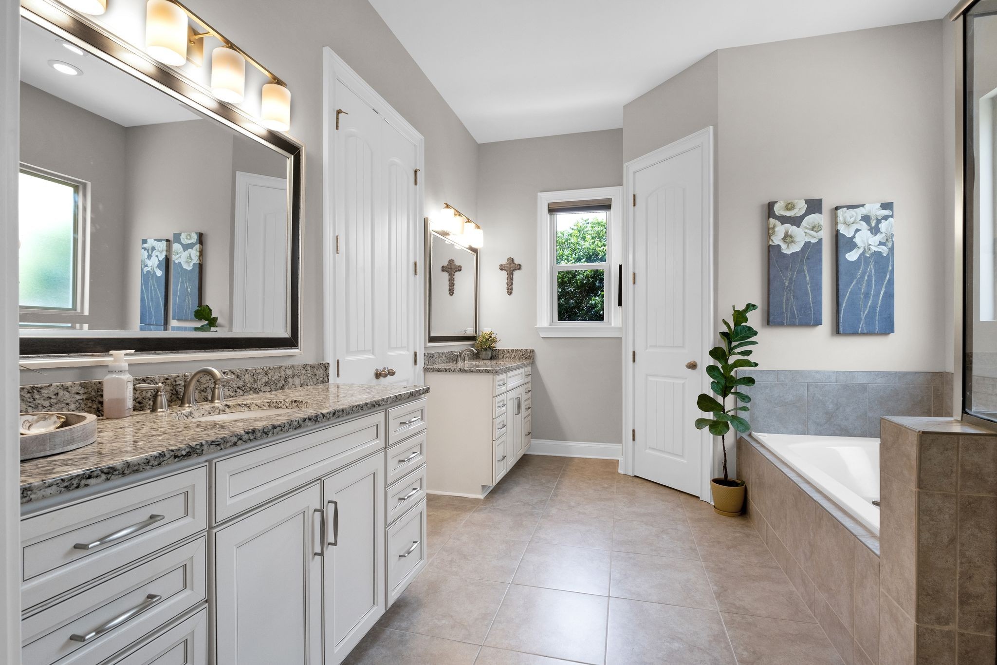 2505 Upper Hollow Road Thompson's Station, TN 37179 - Photo 23 of 52 a spacious en suite bathroom with a double vanity sink a large mirror and a bathtub