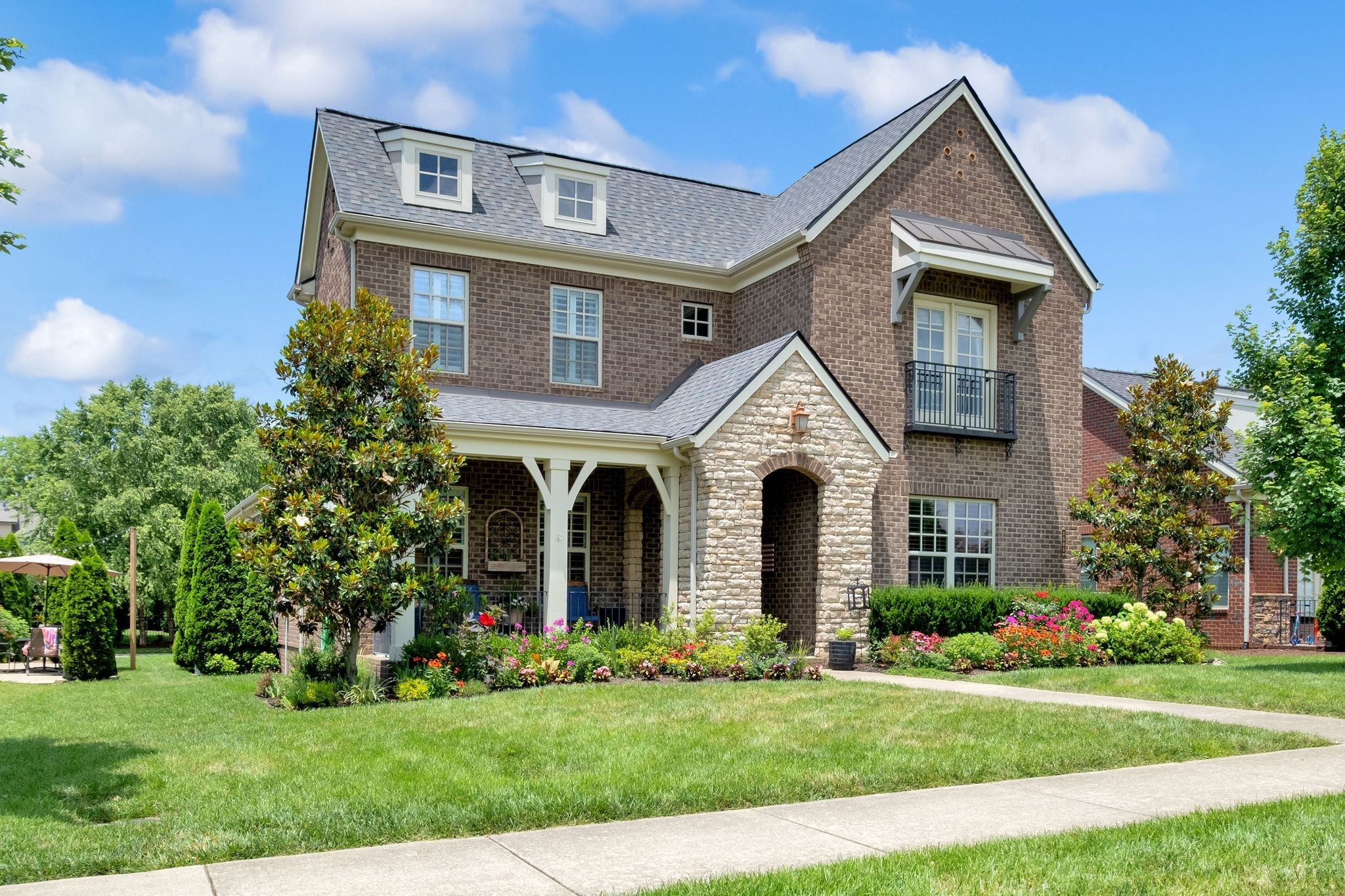 2505 Upper Hollow Road Thompson's Station, TN 37179 - Photo 3 of 52 a front view of a house with a garden and plants
