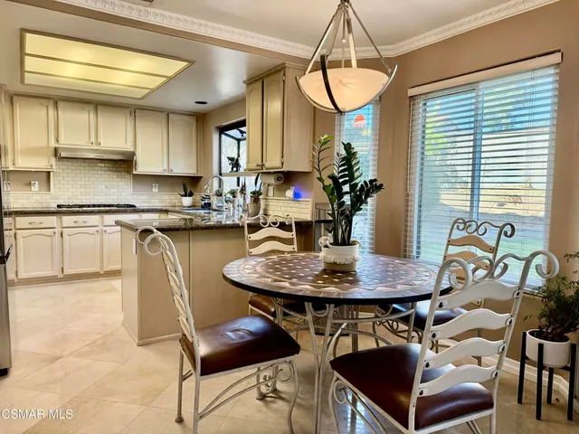 a dining room with furniture and window