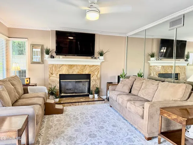 a living room with furniture and a fireplace