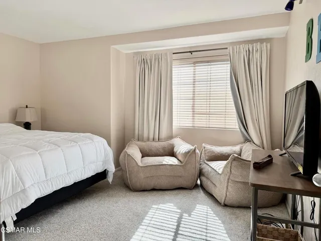 a bedroom with furniture and a window