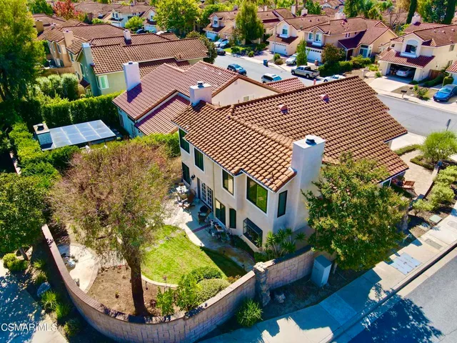 an aerial view of multiple houses with yard