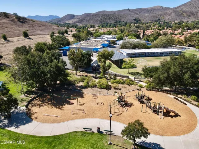 a view of a house with a yard and a lake view