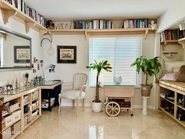 a view of a workspace room with furniture and a potted plant