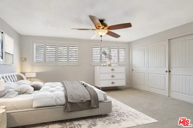 a spacious bedroom with a bed and a window