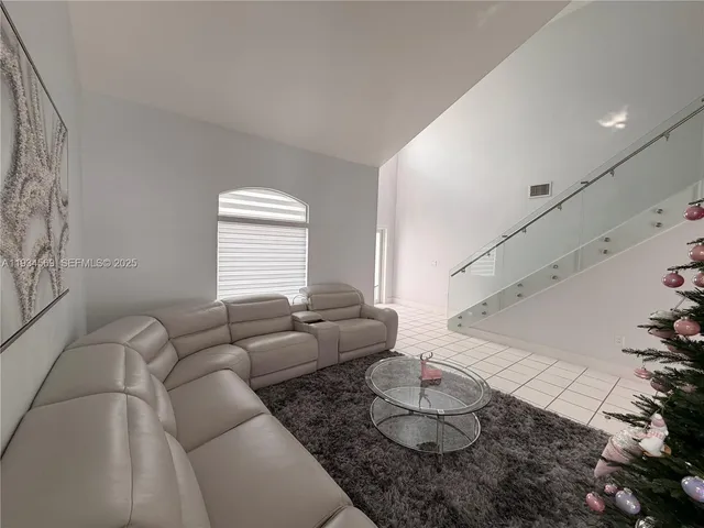 a living room with furniture and a hard wood floor