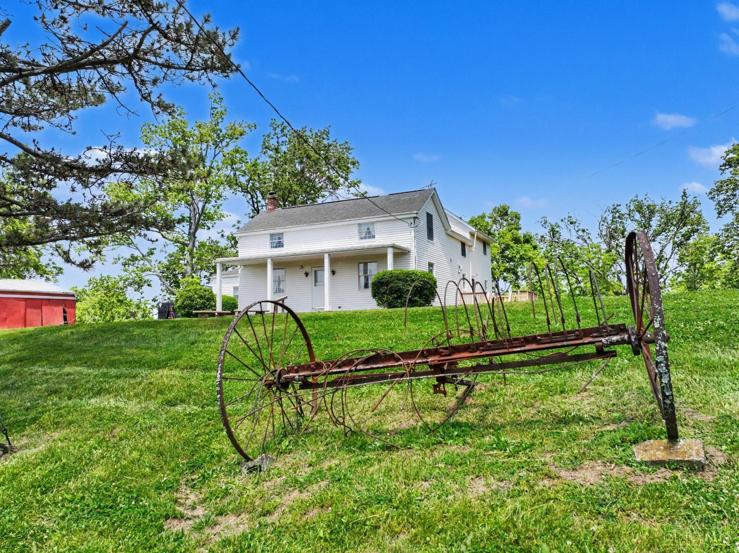 5856 Blue Rock Road Cincinnati, OH 45247 - Photo 2 of 51 Exterior of home with farm equipment nostalgia
