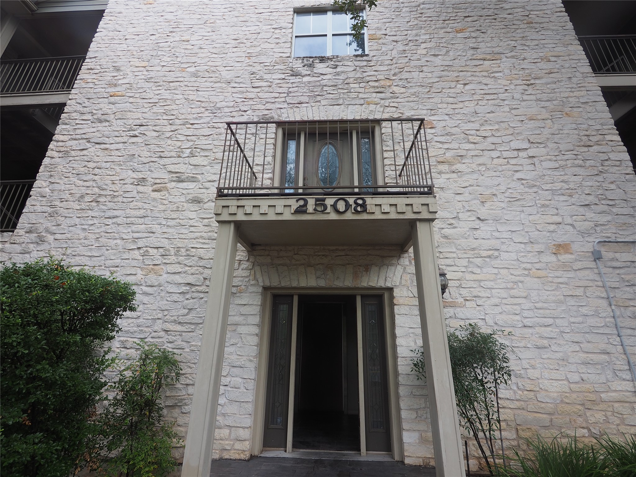 Stone facade exterior with a covered entry
