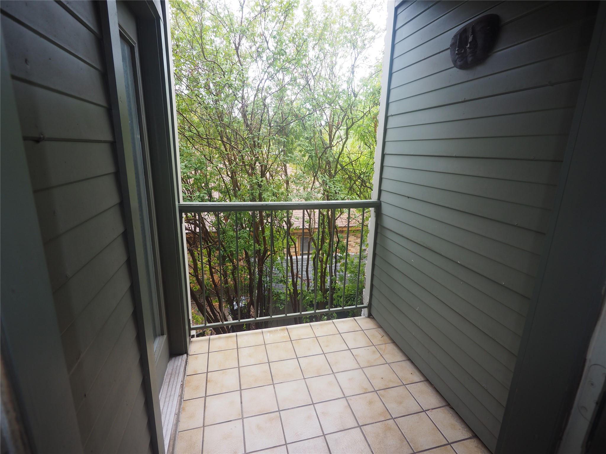 2508 Enfield Road, Unit 10 Austin, TX 78703 - Photo 17 of 17 Balcony with square tile flooring, a metal railing, and horizontal siding
