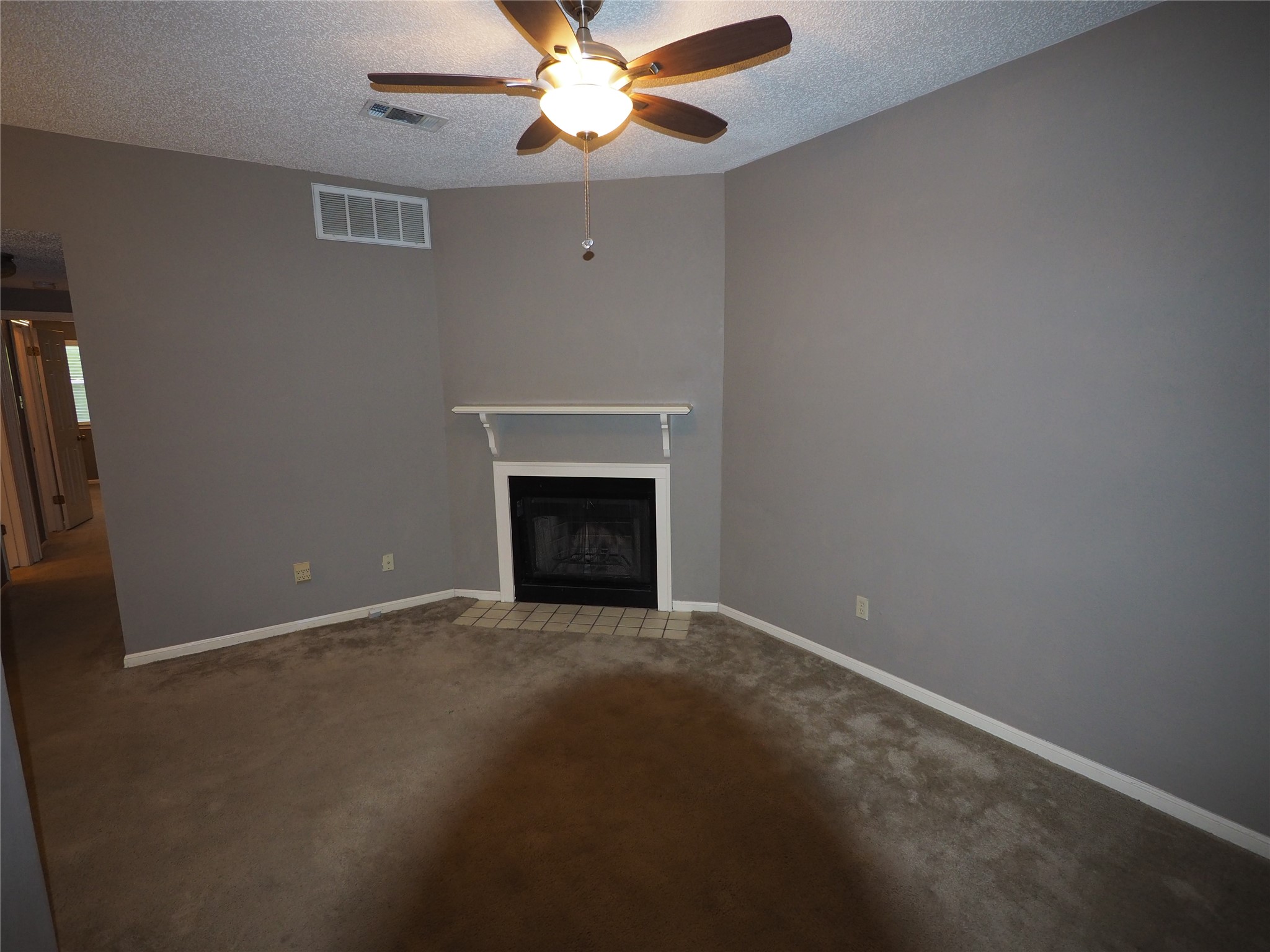 2508 Enfield Road, Unit 10 Austin, TX 78703 - Photo 3 of 17 Neutral tone walls with white trim and carpeting
